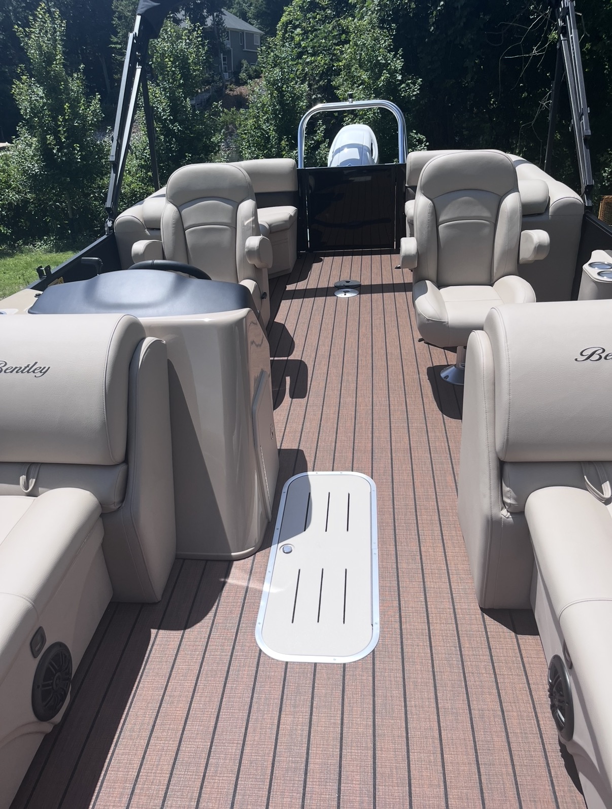 Cream seating and teak-style deck aboard the tritoon