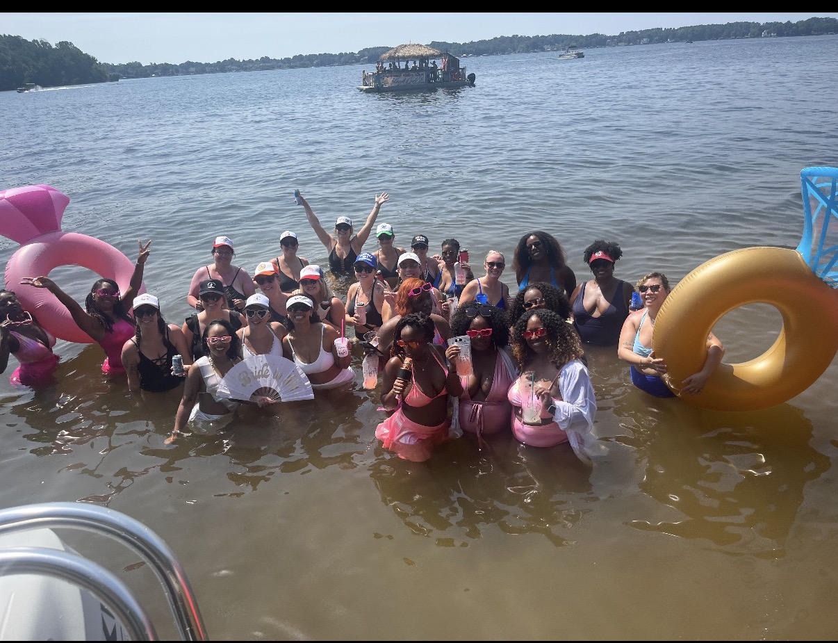 A group celebrating in the shallows of Lake Norman