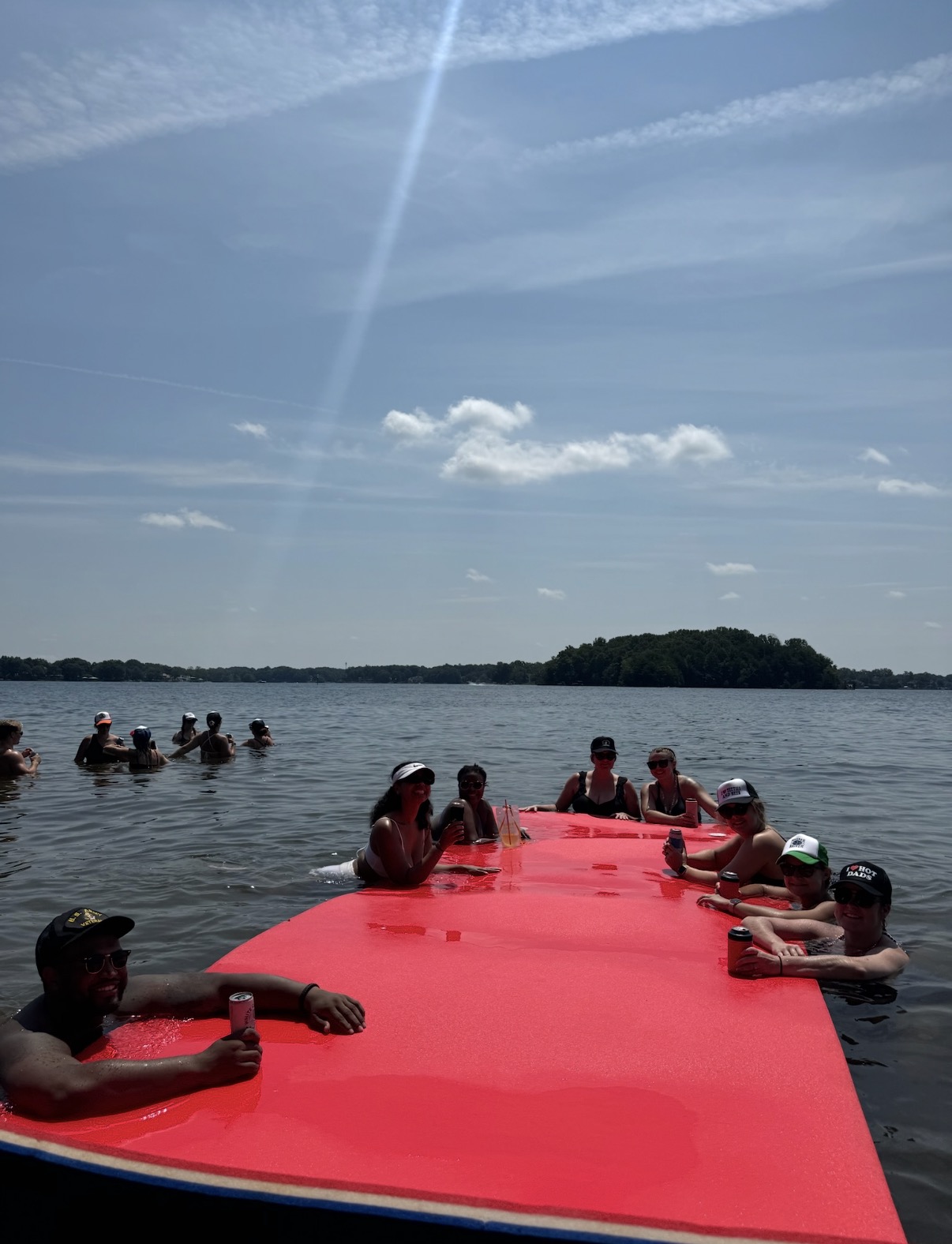 Guests around a floating mat on Lake Norman